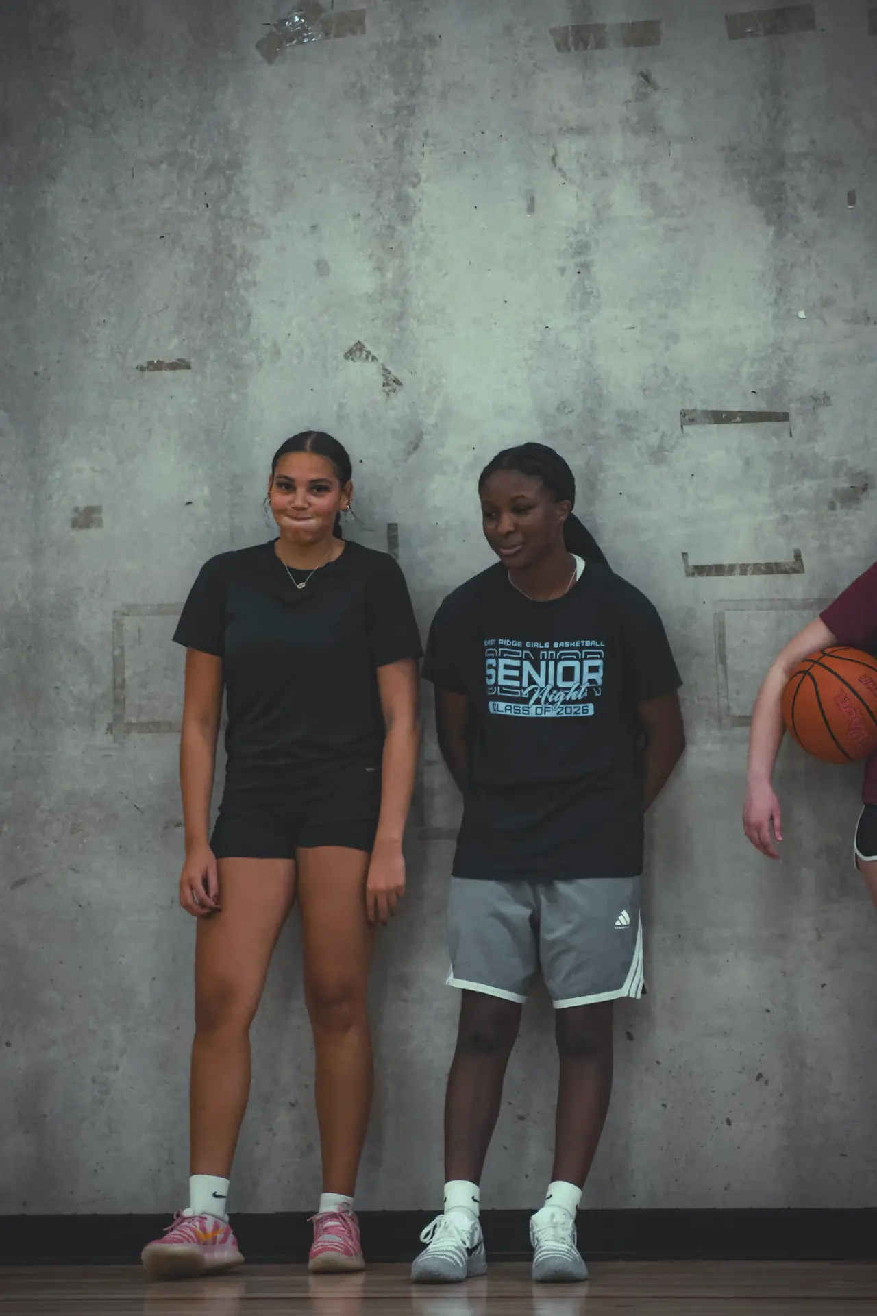 Two athletes sharing a laugh at the baseline