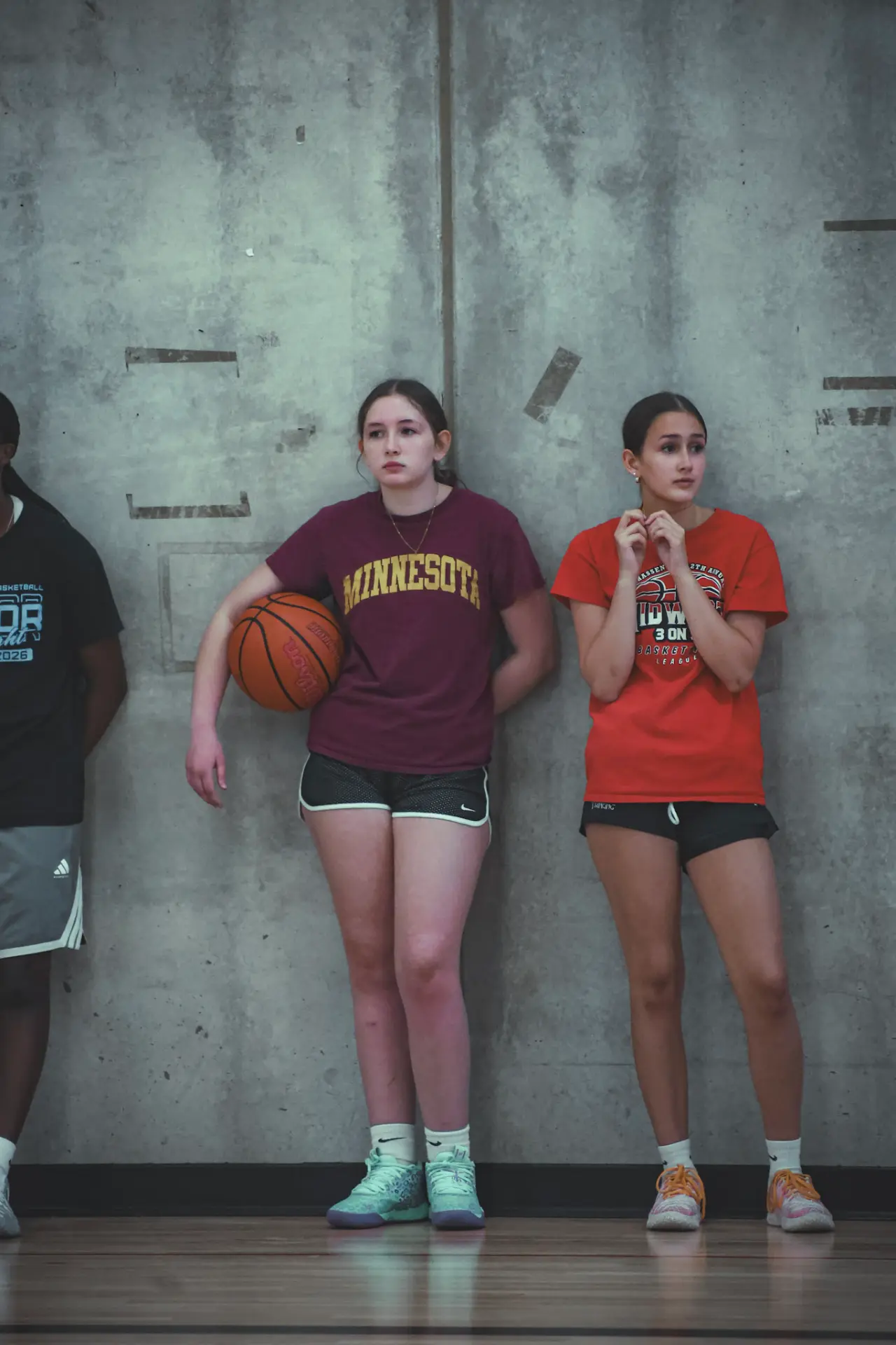 Athletes lined up along the gym wall during tryouts