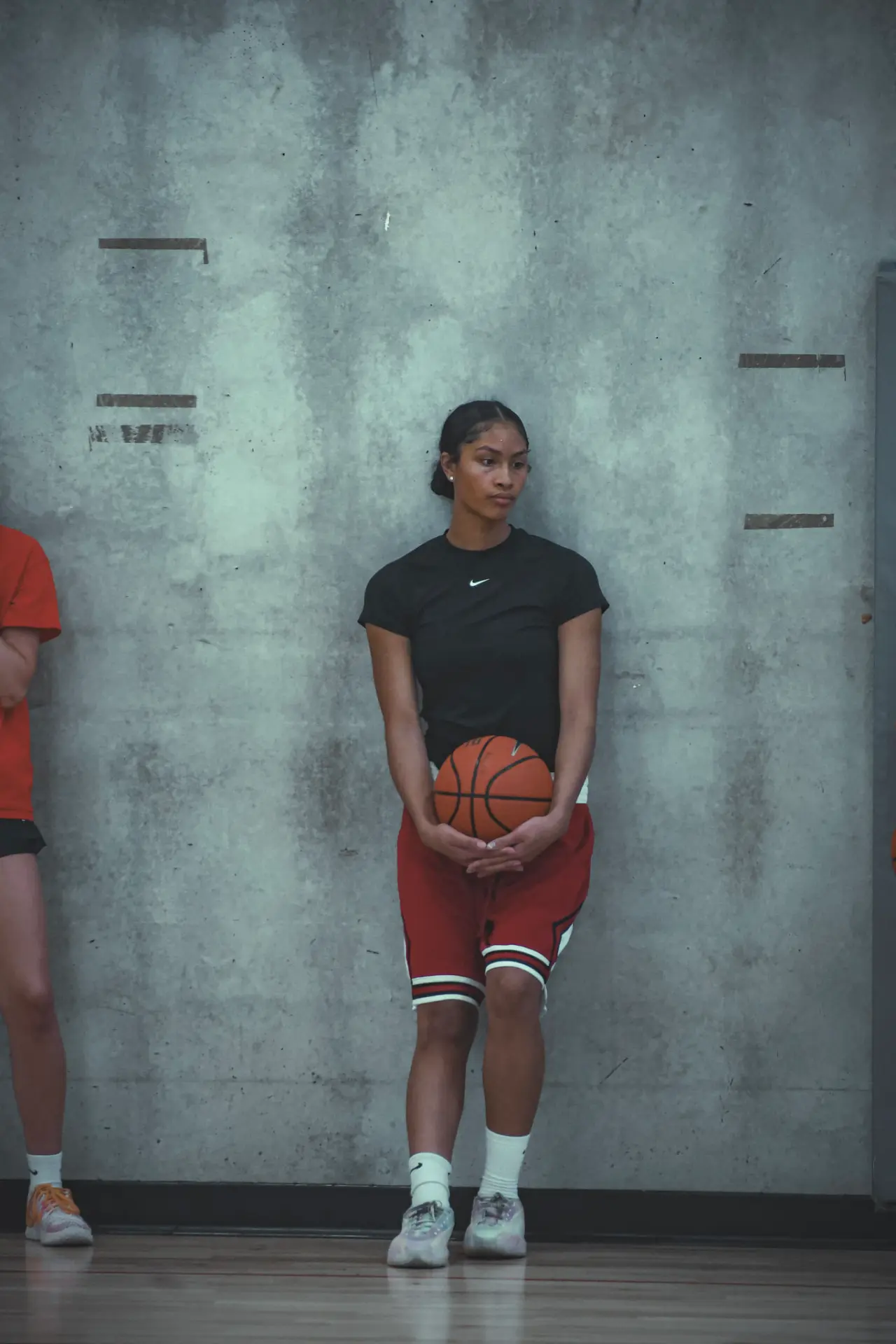 Moore H.Y.P.E. athlete holding a basketball at the wall