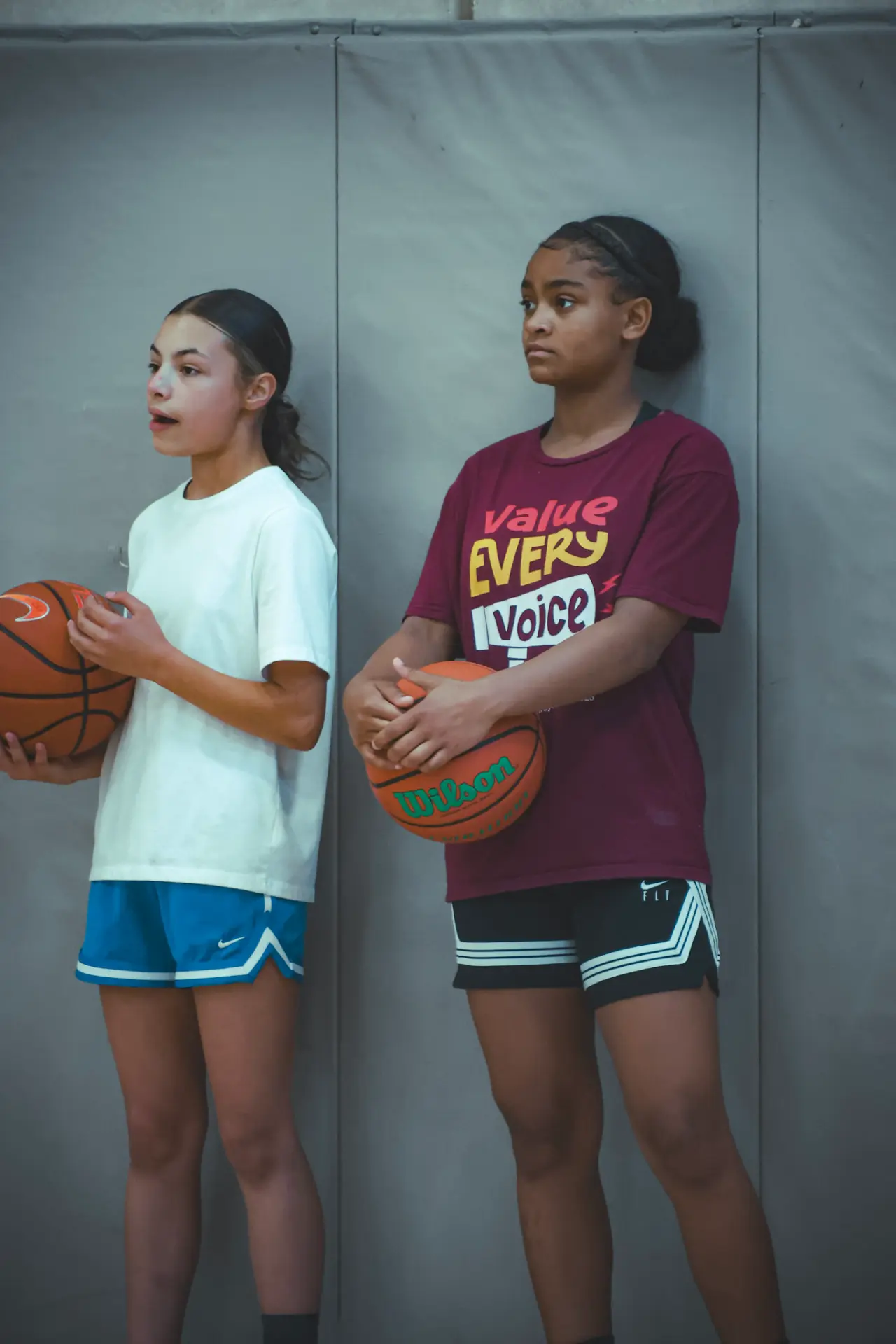 Two Moore H.Y.P.E. athletes waiting with basketballs